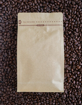 Bag of roasted coffee beans with empty space on a rich dark coffee background