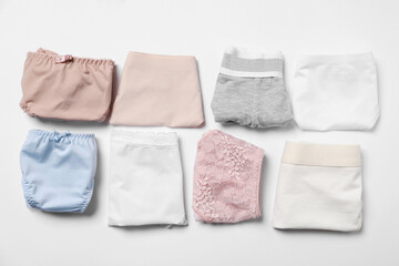 Stylish folded women's underwear on white background, flat lay