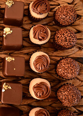 brigadeiros, chocolate balls, brazilian sweets, box of chocolate candies, chocolate candies on a plate, box of chocolates, birthday party, chocolates, top view, candy store, shop window, top view