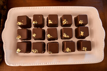 brigadeiros, chocolate balls, brazilian sweets, box of chocolate candies, chocolate candies on a plate, box of chocolates, birthday party, chocolates, top view, candy store, shop window, top view