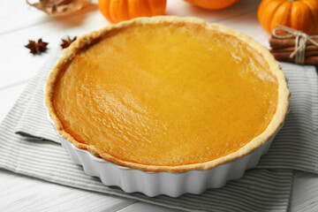 Delicious pumpkin pie on white wooden table, closeup