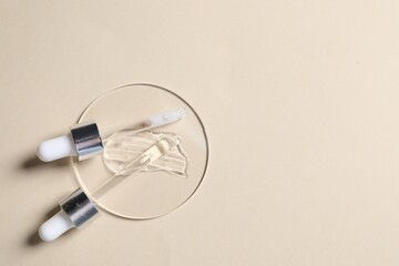 Pipettes, cosmetic serum and petri dish with sample on beige background, top view. Space for text