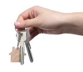 Woman holding keys with keychain in shape of house isolated on white, closeup