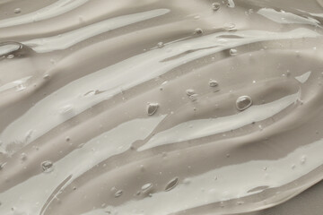 Clear cosmetic gel on grey background, closeup