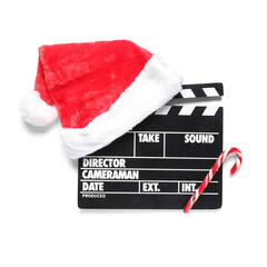 Movie clapper with Santa hat and candy cane on white background