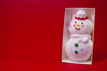 snowman with gifts. Daifuku snowman isolated on red background. Snowman Daifuku, traditional...