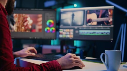 Video editor showcasing his experience with 3D special effects and editing software packages, taking footage shot by production teams and improving it. Videographer finishing project in studio