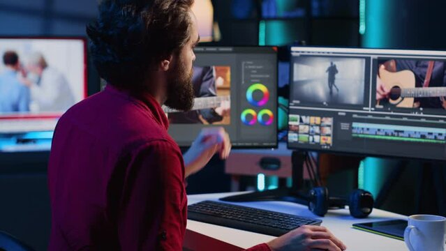 Video editor selecting key frames to use while doing video montage, using specialized software applications. Freelancer using editing tools on computer to cut movie project footage in office