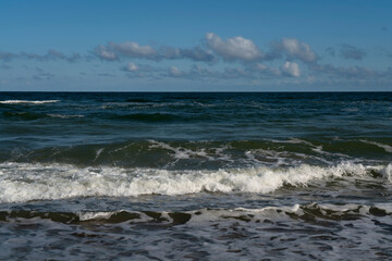 Fototapeta premium View of the incoming wave on the Baltic Sea on the shore of the Curonian Spit on a summer day,
