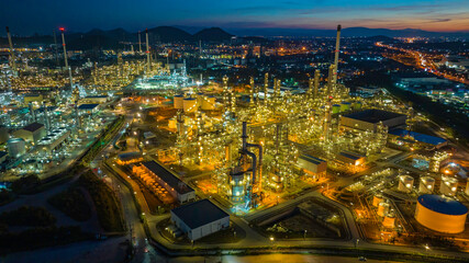 Fototapeta na wymiar Aerial view of the morning of the oil refinery from the drone of the tower of the Petrochemistry industry in the oil​ and​ gas​ ​industry with​ cloud​ sun orange​