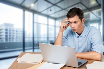 business man has stress and headache works in office