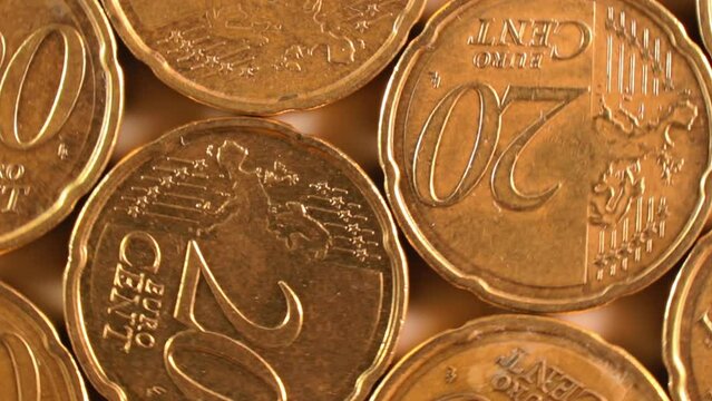 20 Euro Cent Coins, Rotating Money Background - Top View, Macro. Euro Money Currency. A Lot of Twenty Cent Cash. Golden Eurocents. Business, Finances and Money Saving Concept - Slow Rotation Right