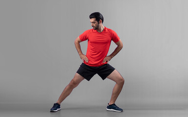 Full body length gaiety shot athletic and sporty young man with fitness warmup and stretching body...