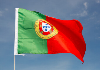 Close-up picture of national flag of Portuguese Republic on blue sky background