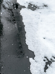 first snow on the pavement. melting snow on the road.