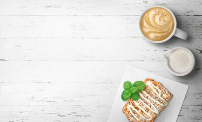 Cafe latte and pastry with foam design on a white empty background with space