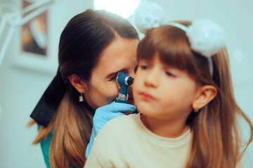 Doctor Holding Otoscope a Doing a Pediatric Ear Examination. Little kid having problem with otitis...