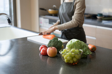 No face cutting fresh vegetables in the kitchen Close-up of hands only