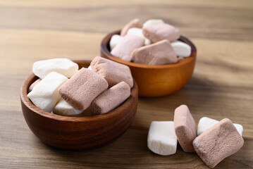 Marshmallow chocolate and vanilla in bowl on wooden background