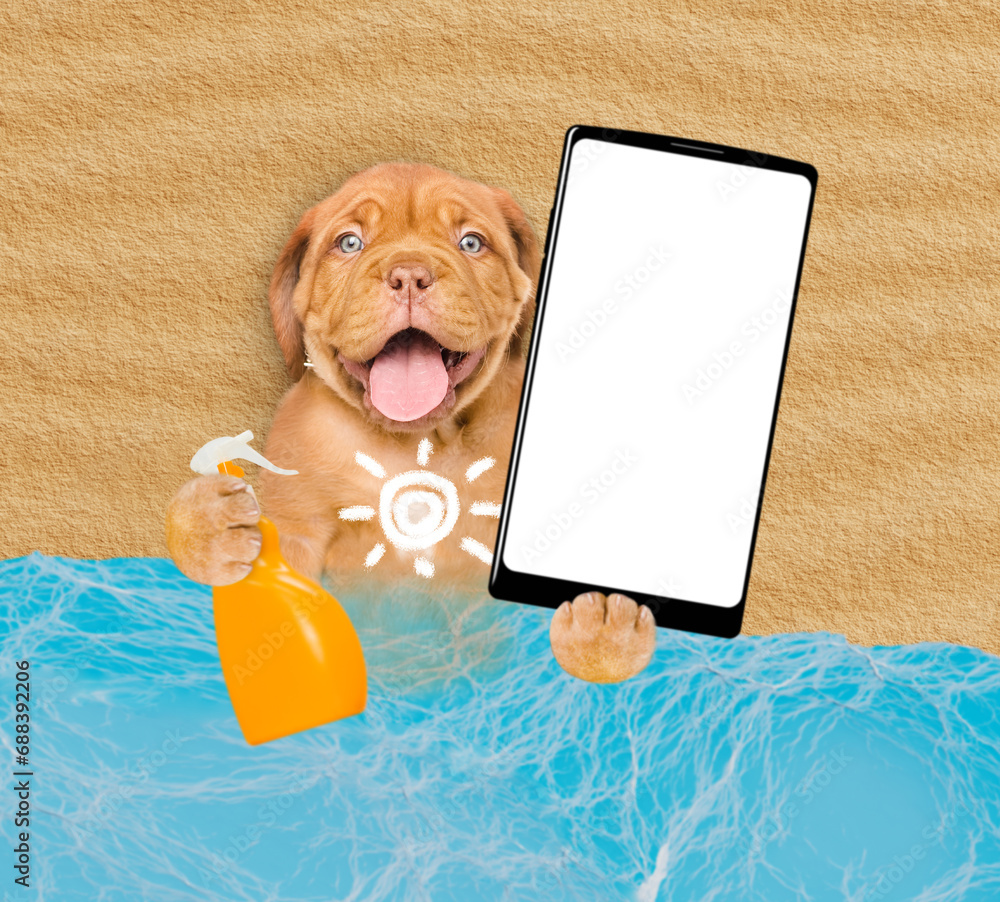 Poster funny mastiff puppy at beach applying suntan lotion or sun block and showing big smartphone with whi