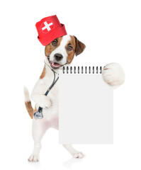 Smart jack russell terrier wearing like a doctor with stethoscope on his neck shows empty notebook. isolated on white background