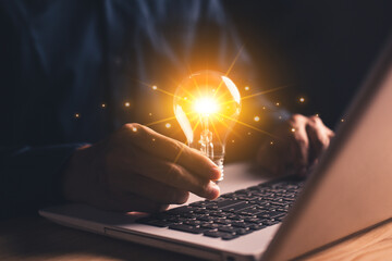 Innovation through ideas and inspiration ideas. Innovation technology. Human hand holding light...
