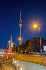 The famous Television Tower of Berlin and the chruch of St. Mary at night
