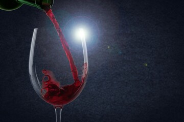 Poring red tasty sweet wine in a glass