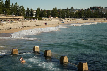People swimming at Rockpool, Coogee Beach, Sydney Australia 