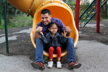 Divorced single dad and brown latino 4 year old daughter spend quality time playing on park games...