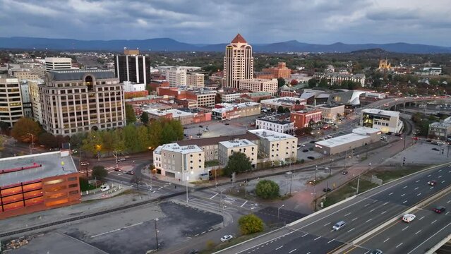 Downtown Roanoke VA at dawn. Aerial view of highway traffic and skyline during blue hour sunrise.
