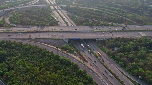 Aerial shot of elevated highway road junctions. The Intersecting freeway road overpass. Overhead Shot of nehru outer ring road Highway showing multiple Roads in Devatabowli, hyderabad, telangana