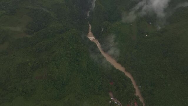 Aerial view of brown cahabon river at Guatemala during rain season, drone