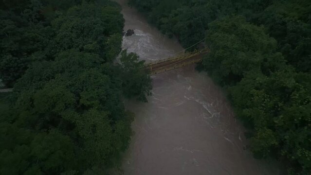 Drone view of yellow bridge crosses the cahabon river at Semuc champey, aerial