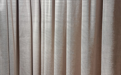 Fototapeta premium close up beige curtains use as background. sack cloth texture drape for minimal interior design. brown natural linen drape curtains background. beautiful interior home design backdrop.