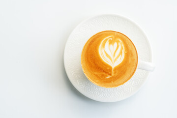 A cup of hot coffee latte with latte art on white table