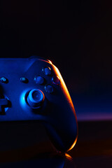 Gaming joystick on black background in neon light