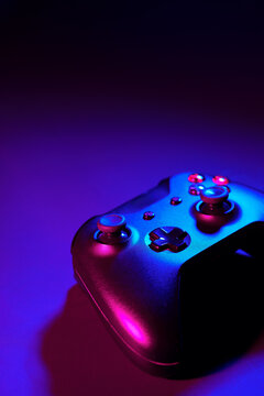 Gaming joystick on black background in neon light