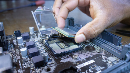 Plugging CPU microprocessor to motherboard socket. computer hardware  repair .