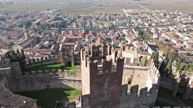 Imposing Fourteenth-Century Castle Tower With Italian Flag In Soave Town, Verona Italy. Aerial Drone Shot