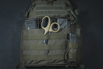 Plate carrier with magazines from ar 15 and medical tactical scissors.