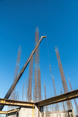 Obraz premium View of a large construction site with buildings under construction and multi-storey residential homes.Tower cranes in action on blue sky background. Housing renovation concept. Crane during formworks