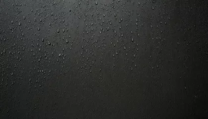 Fotobehang raindrops on a black wall © NizuCaCi