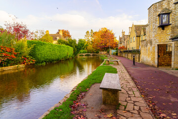 Sunset of typical houses, and the river Windrush, in Bourton-on-the-Water