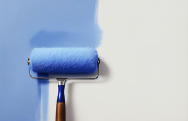 A blue paint roller with a white handle, which is being used to paint a wall