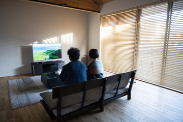 No faces of couples or married couples spending time in their rooms watching movies Wide-angle full...