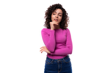 young well-groomed stylish curly brunette lady dressed in a purple turtleneck on a white background with copy space