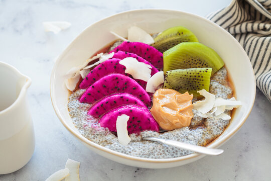 Chia pudding with tropical fruits: pittaya, kiwi, coconut and peanut butter.