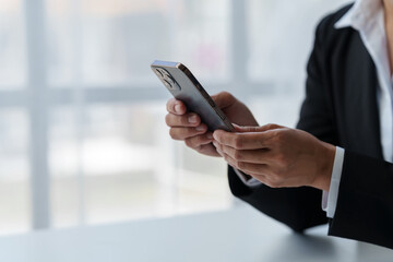 Businesswoman, investor analyzing stock market investment with financial panel, business intelligence on smartphone and laptop computer screen. Focus image. Concept. Technology. Communication.