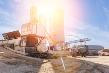 Banner industry cement factory, sunlight. Mixer truck delivery concrete mortar, Transportation to construction site - obrazy, fototapety, plakaty